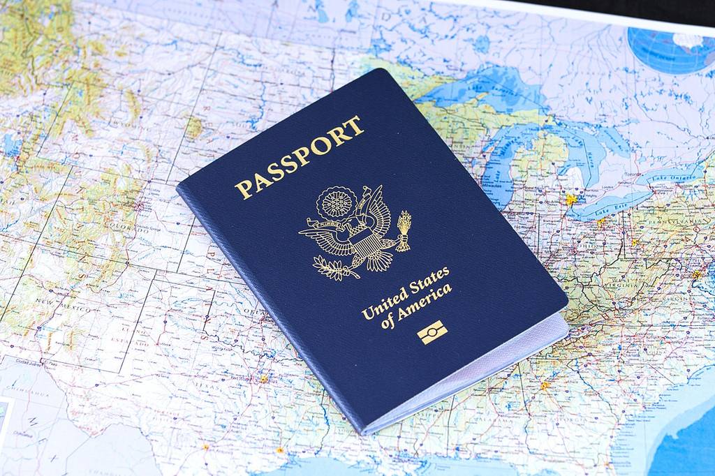A United States passport resting on a map of the country